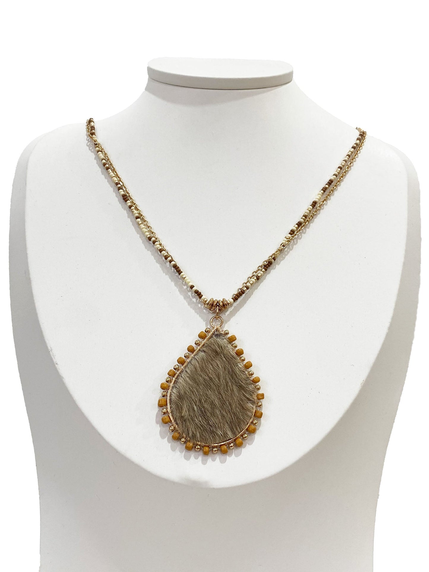 Necklace with a pendant on a white mannequin bust