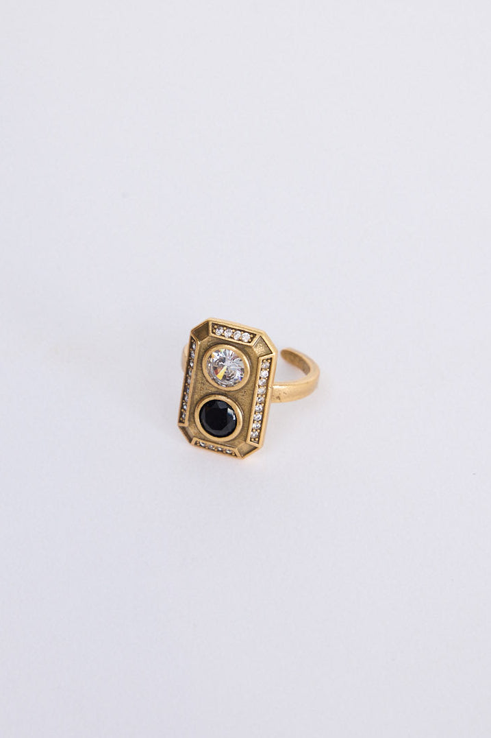 Zephyr Ring in gold with geometric face and stone detailing, front view on white background