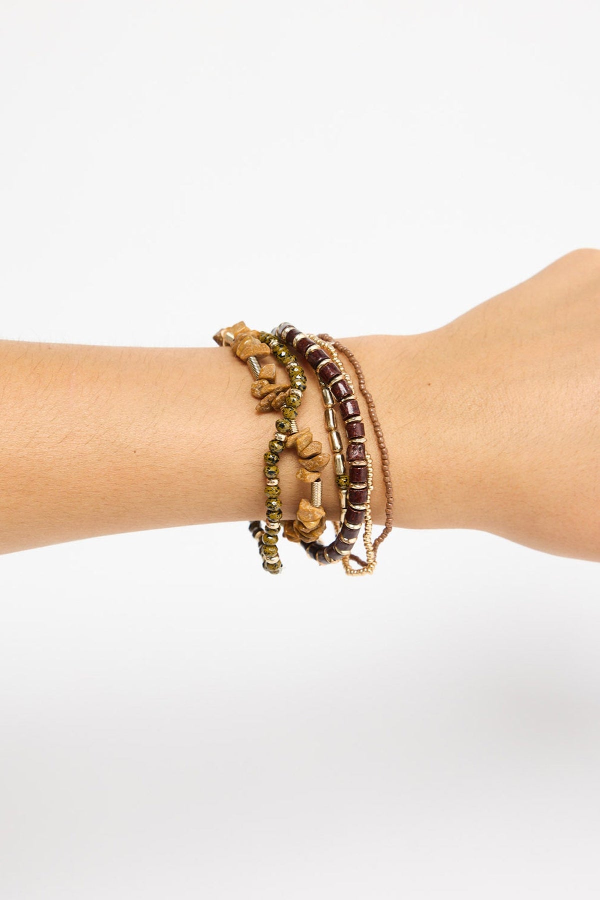 Solidarity Stack Bracelet in Natural worn stacked on the wrist, showing the multiple beaded strands layered together