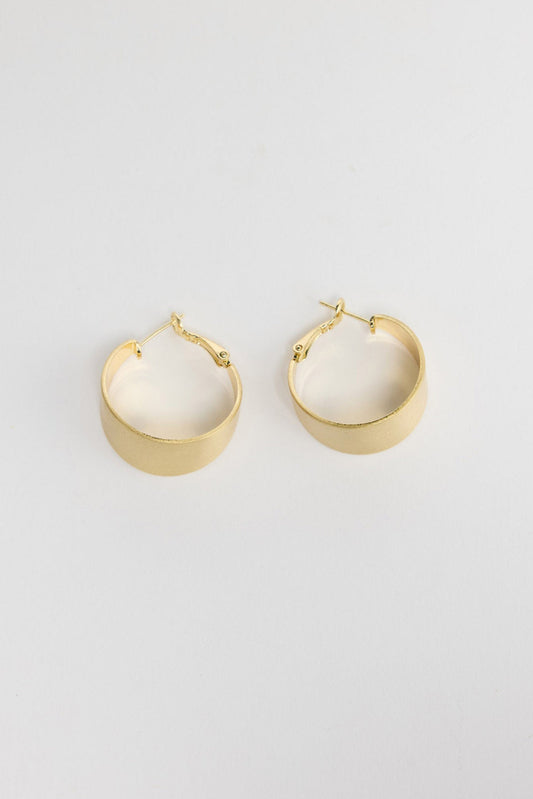 Siren Earrings in Gold, alternate angle showing the width and satin finish of the gold hoop.
