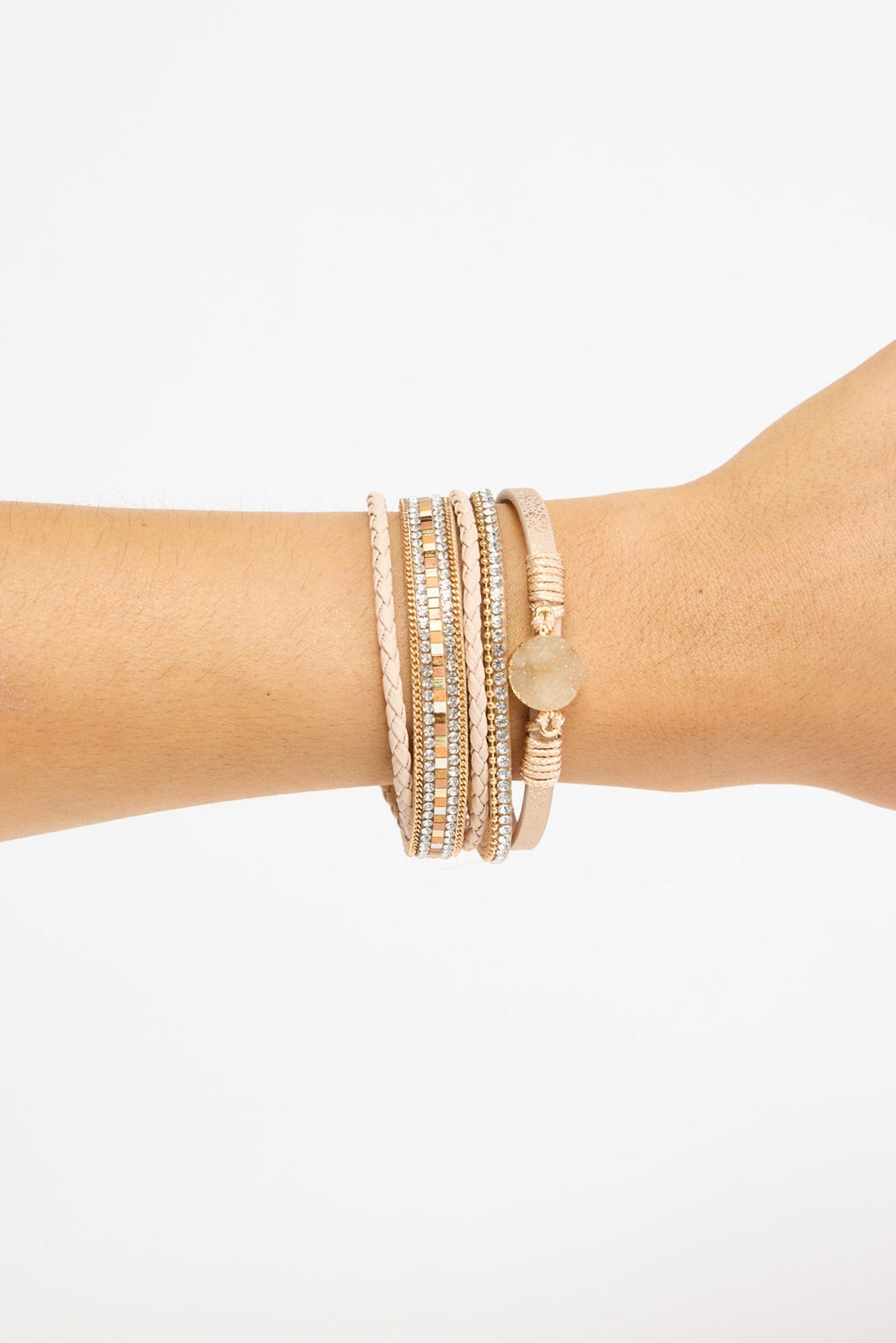 Kasey Bracelet in Beige worn on the wrist, showing the layered beige strands, crystal rows and druzy stone charm.