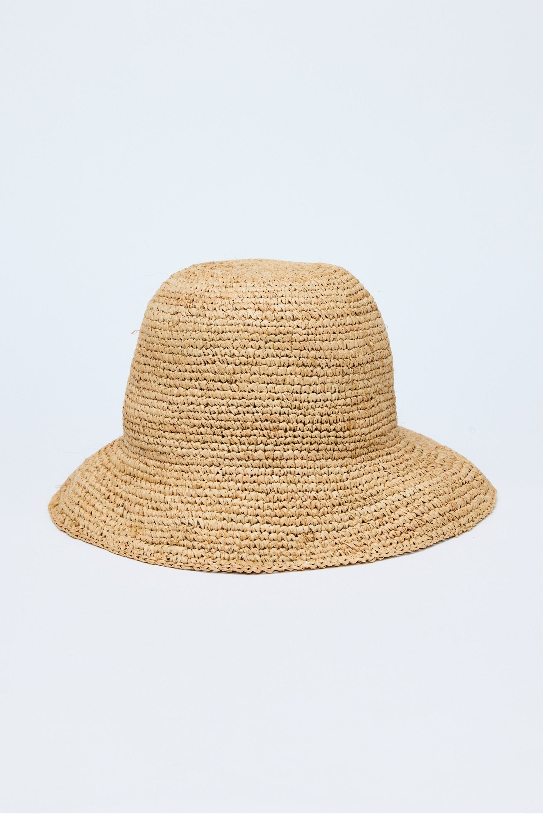 Beige straw hat on a light purple background
