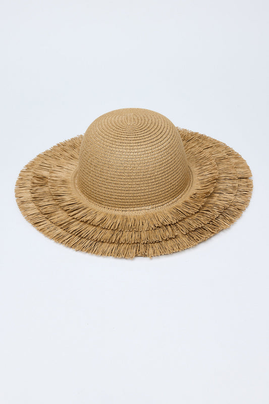 Beige straw hat with frayed edge on a light gray background