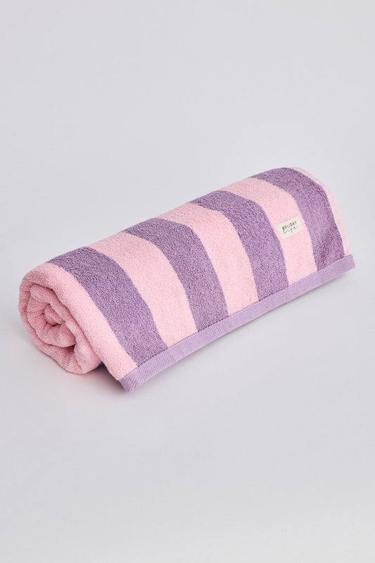 Folded towel with pink and purple stripes on a light gray background