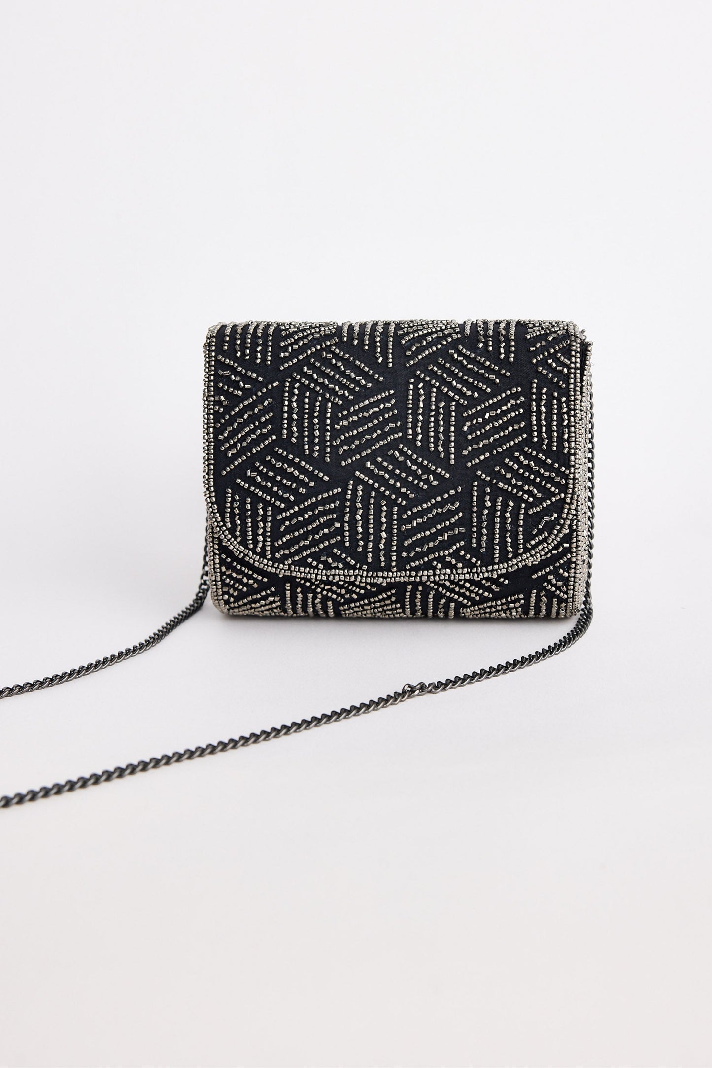 Black beaded handbag with geometric pattern on a white background