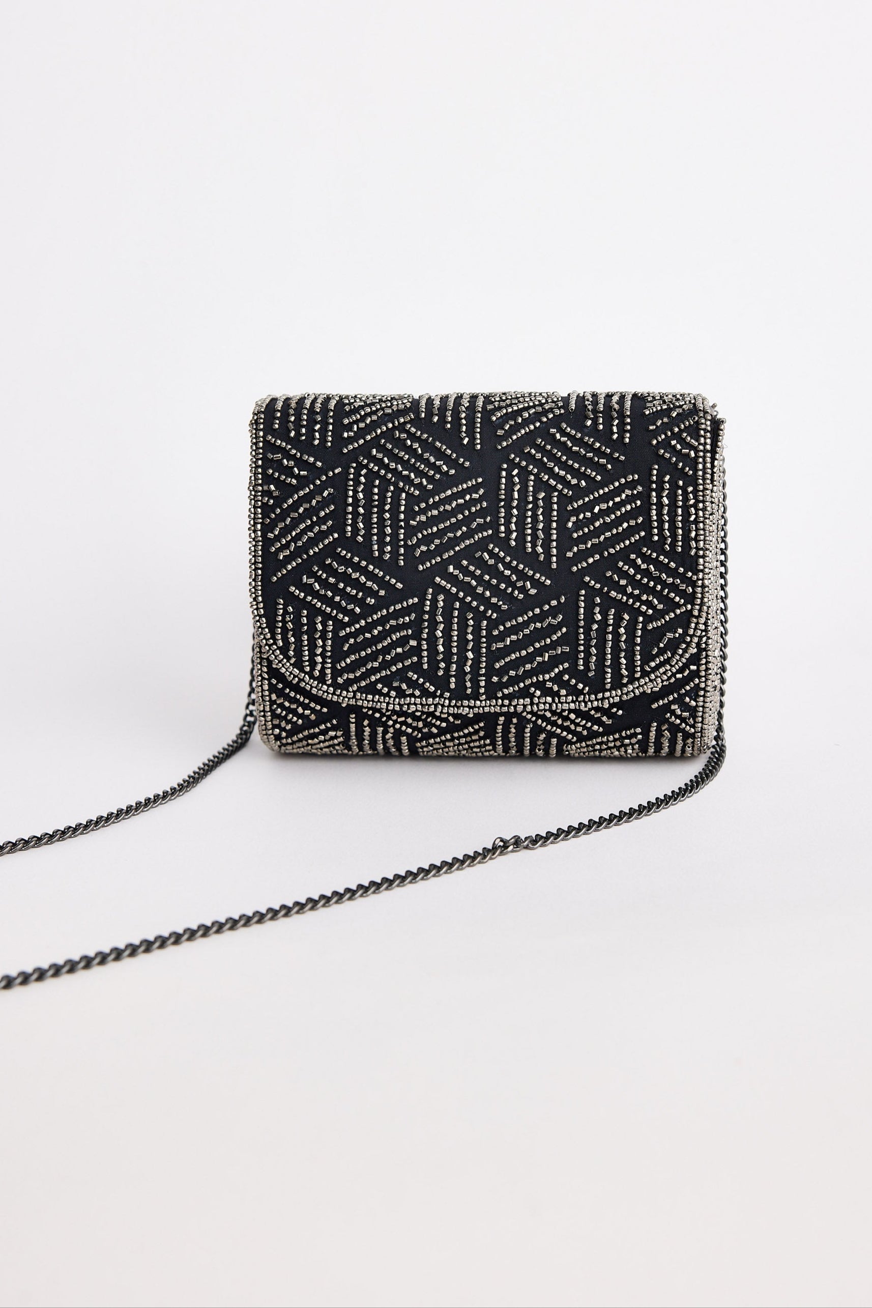 Black beaded handbag with geometric pattern on a white background