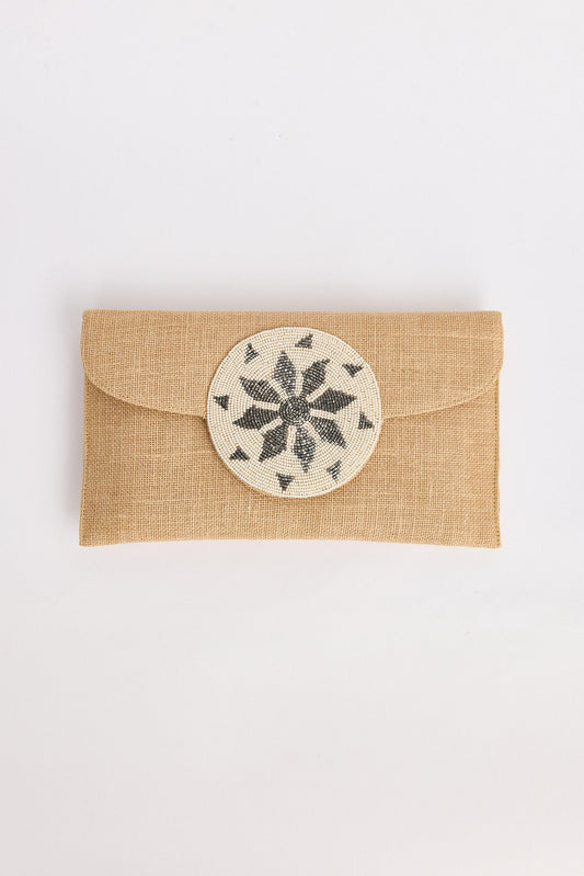 Beige fabric pouch with a round decorative patch on a white background