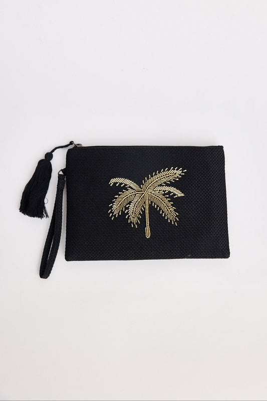 Black clutch with gold palm tree design on a white background