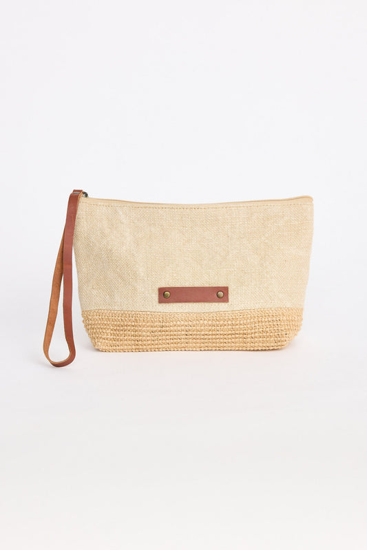 Woven clutch bag with leather strap on a white background