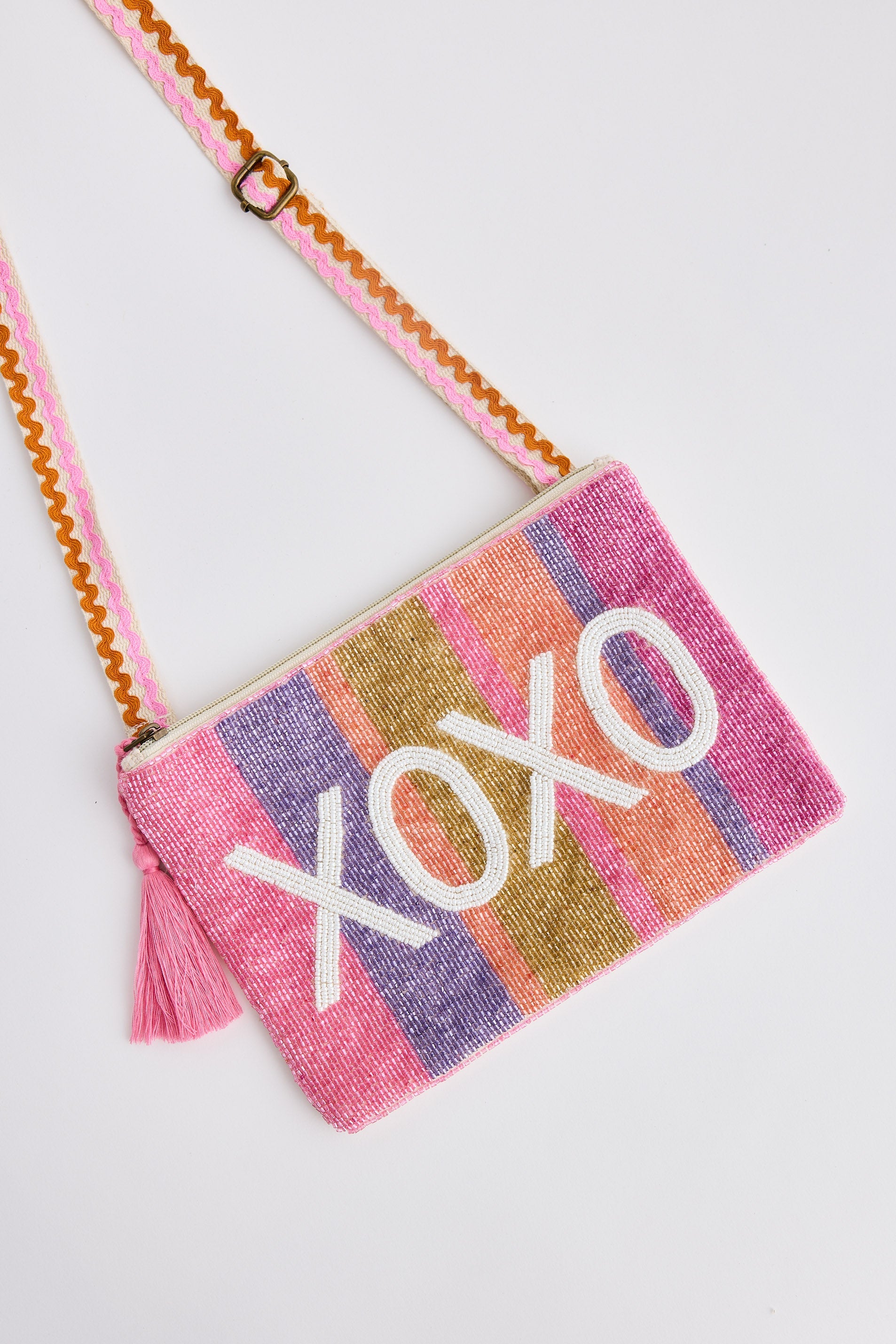 Colorful crossbody bag with 'XOXO' text on a light gray background