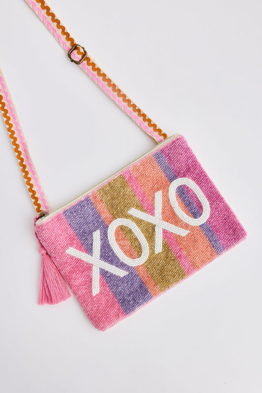 Colorful crossbody bag with 'XOXO' text on a light gray background