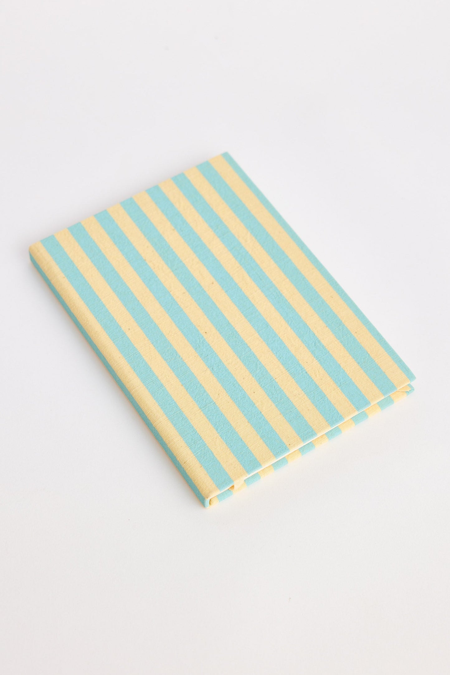 Blue and yellow striped notebook on a white background