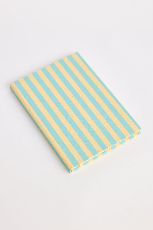Blue and yellow striped notebook on a white background