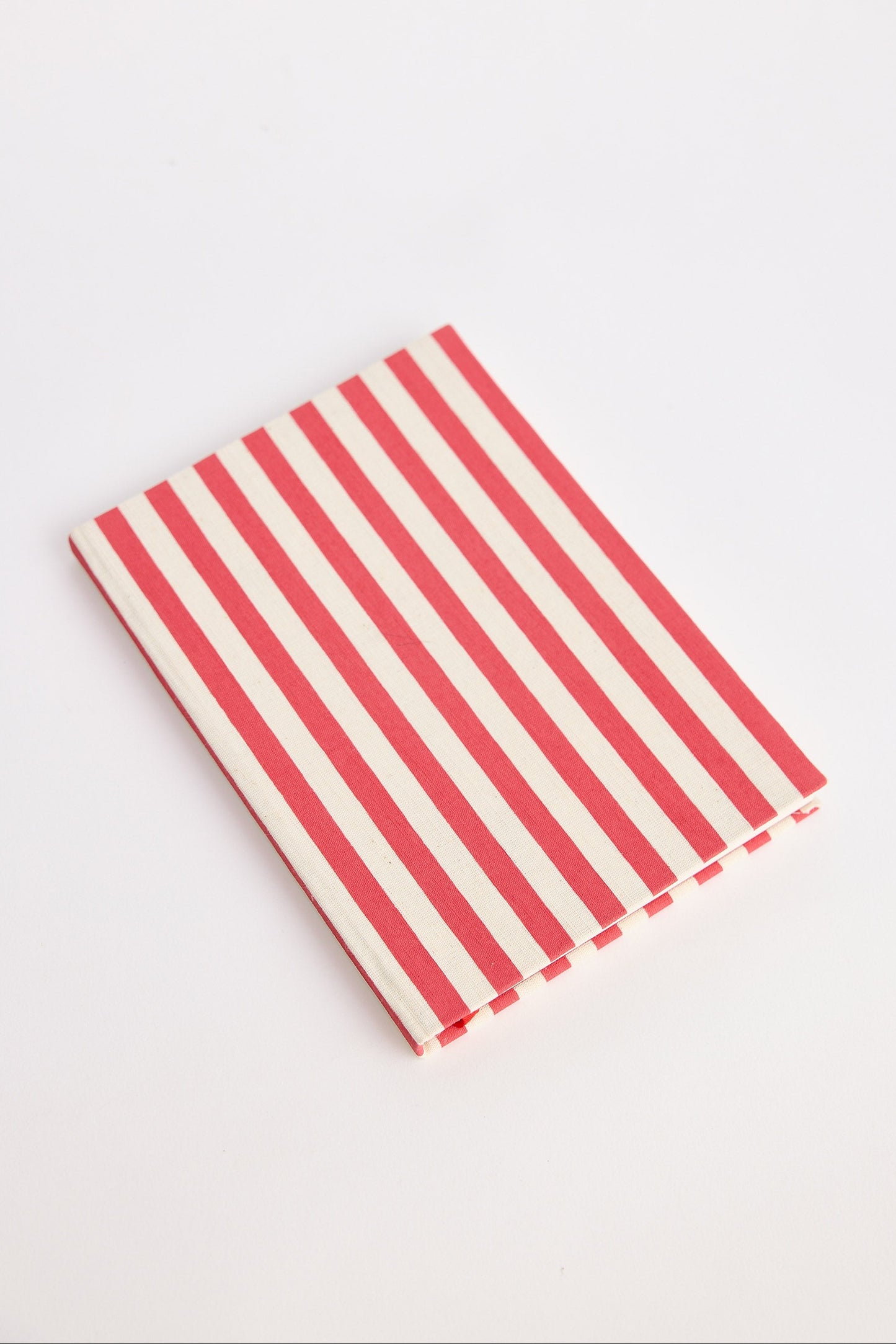 Red and white striped notebook on a light gray background