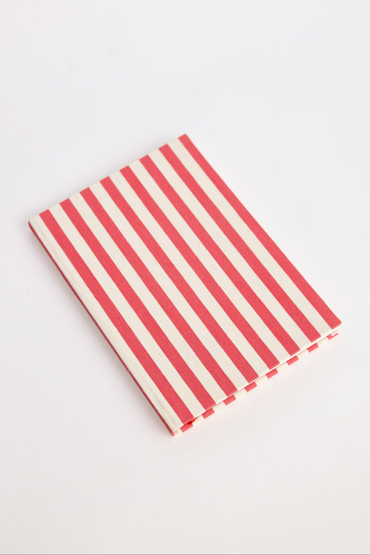 Red and white striped notebook on a light gray background