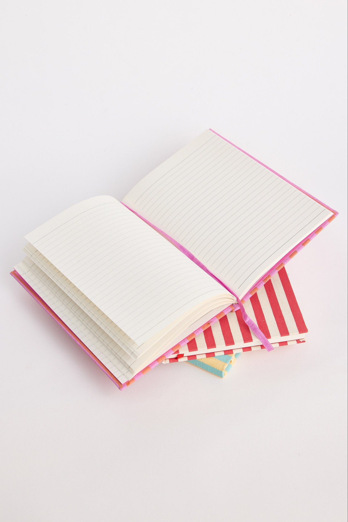 Open notebook with striped cover on a white background
