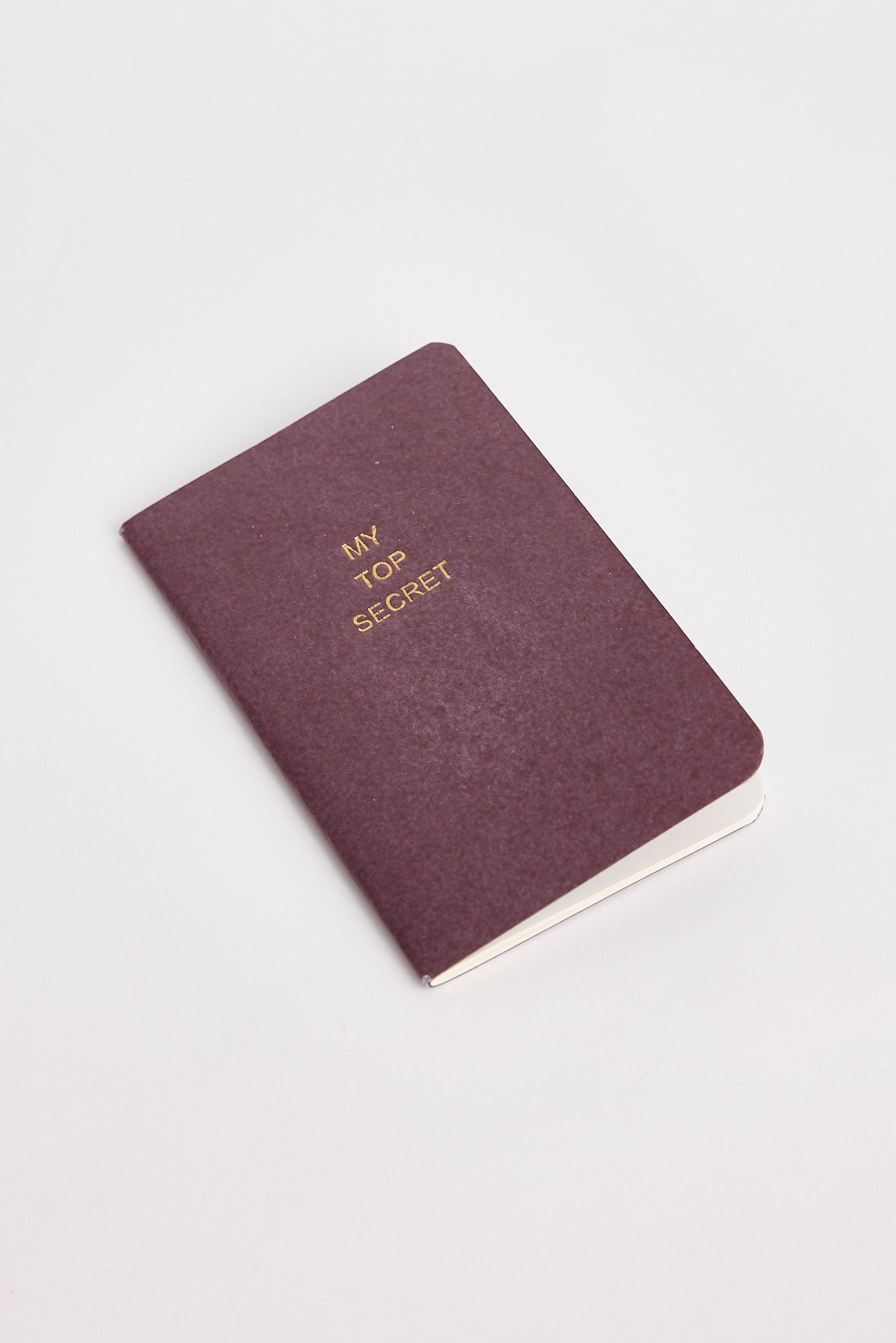 Maroon notebook with 'My Top Secret' text on a white background
