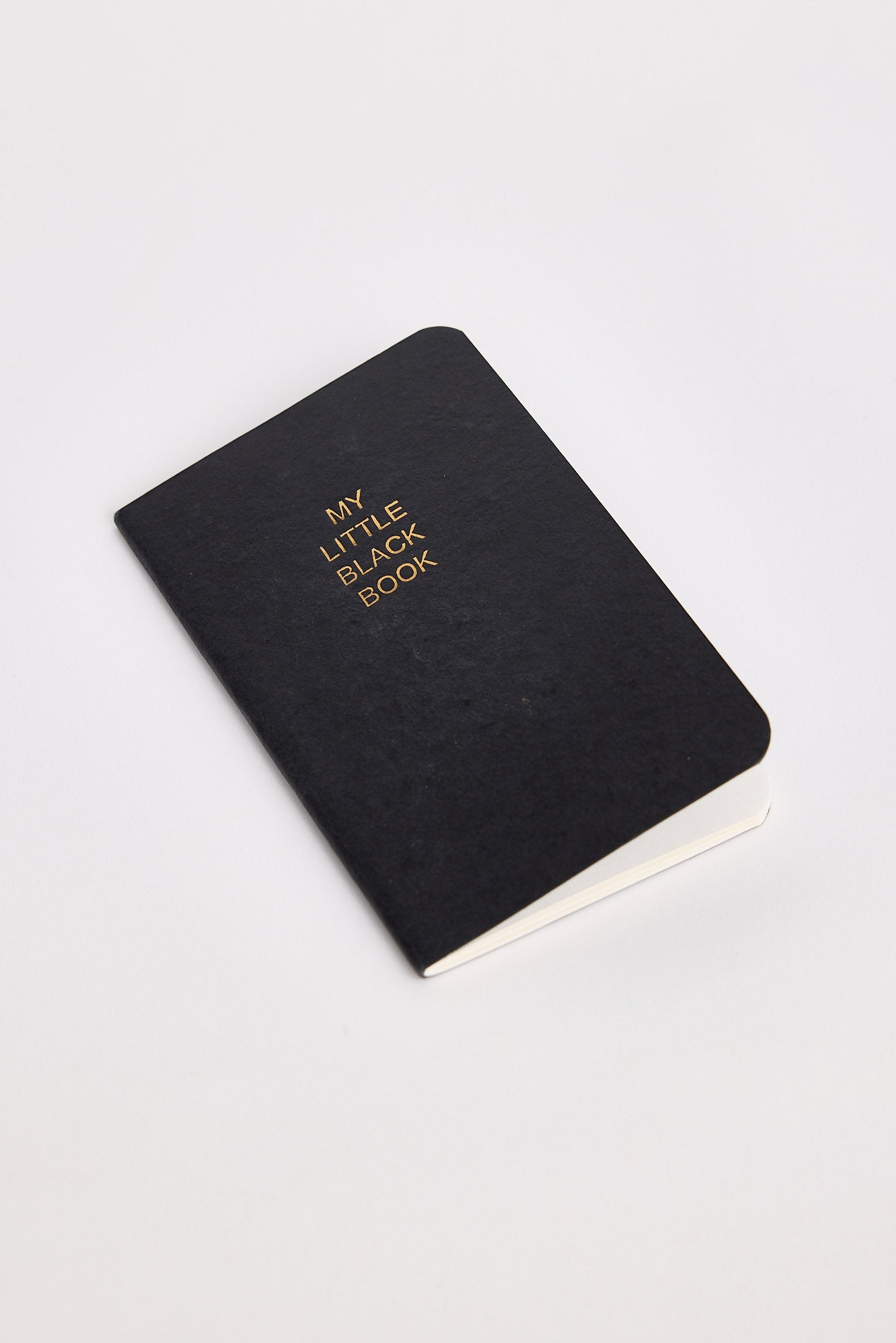 Black notebook with 'My Little Black Book' text on a white background