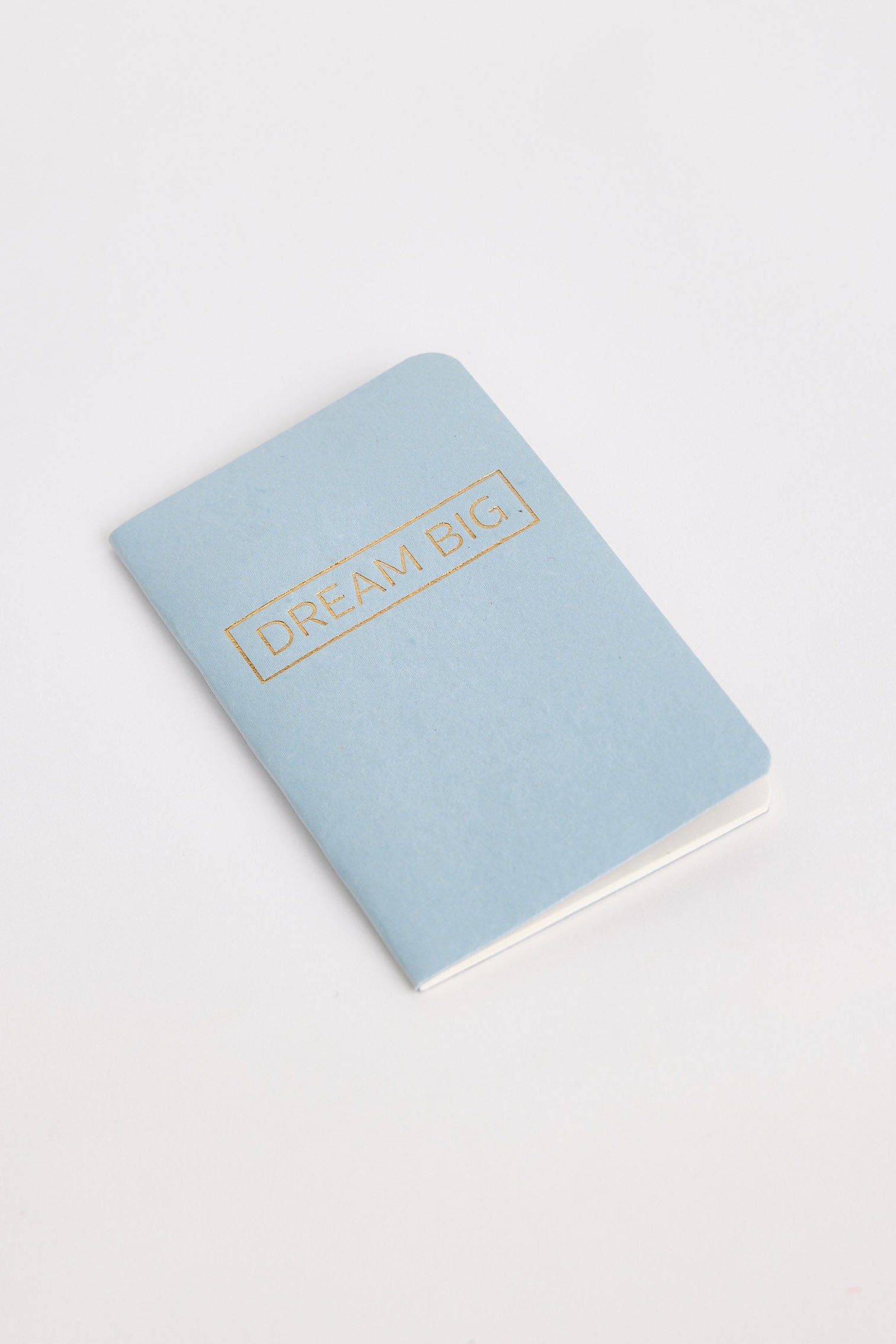 Light blue notebook with 'Dream Big' text on a white background