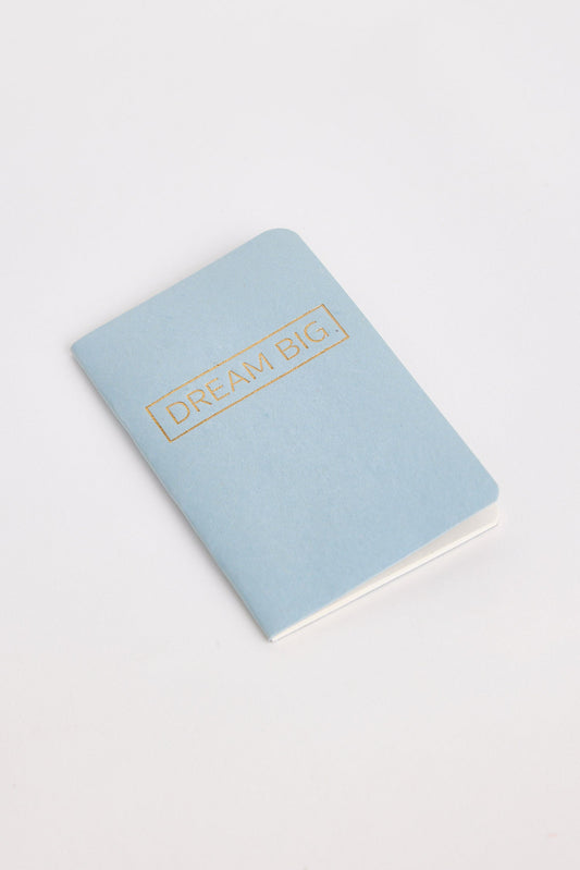 Light blue notebook with 'Dream Big' text on a white background