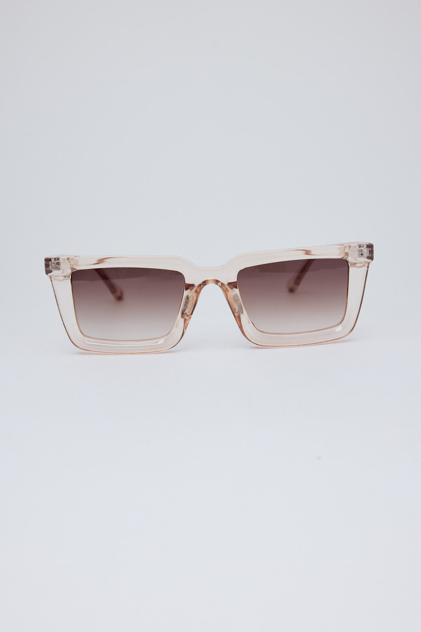Sunglasses with a gradient lens on a light gray background
