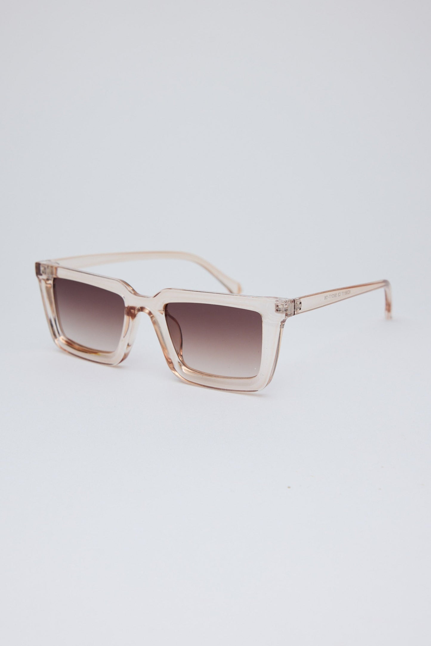 Sunglasses with a gradient lens on a light gray background
