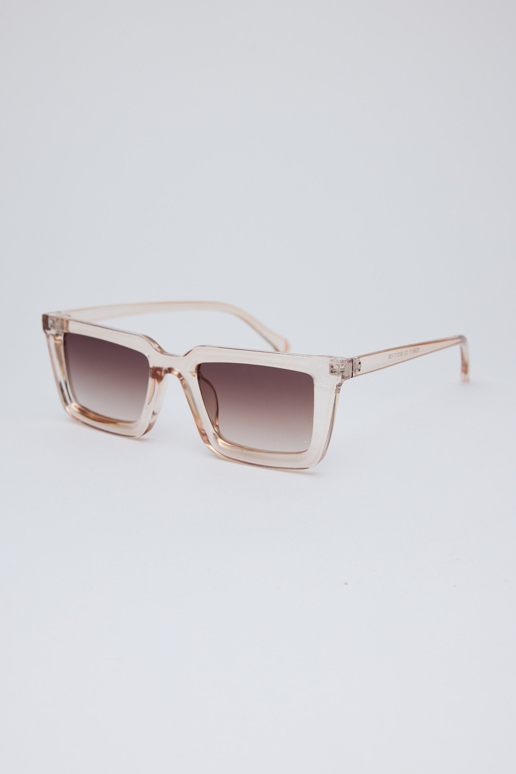 Sunglasses with a gradient lens on a light gray background
