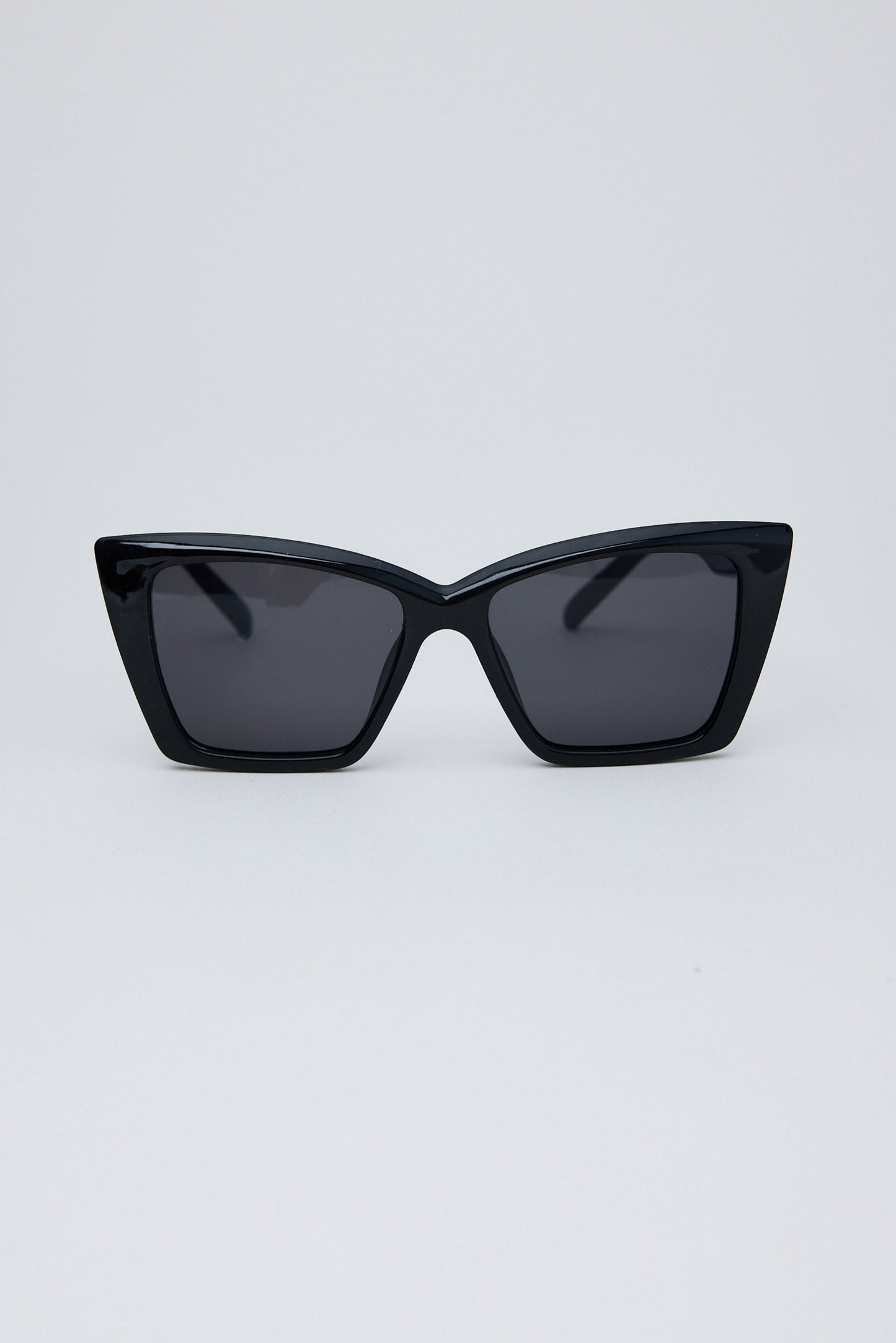 Black cat-eye sunglasses on a light gray background
