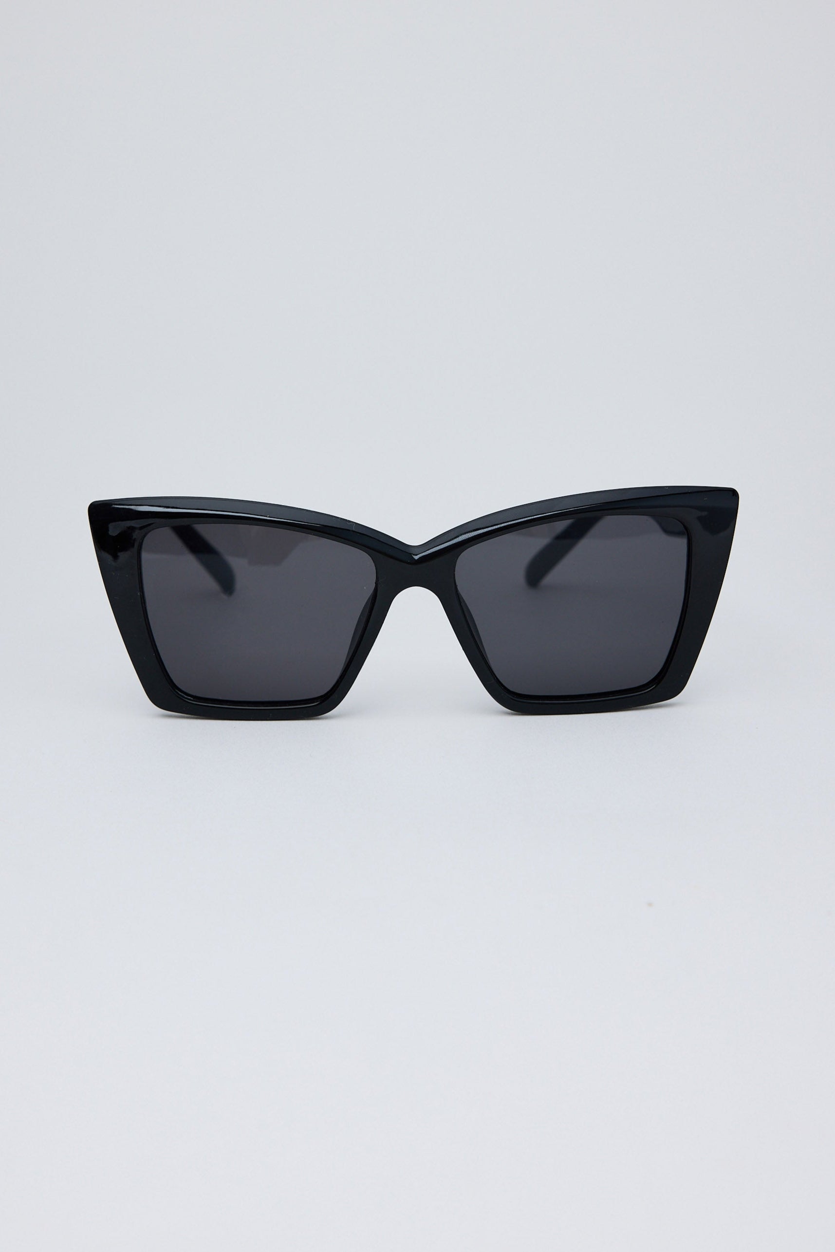 Black cat-eye sunglasses on a light gray background