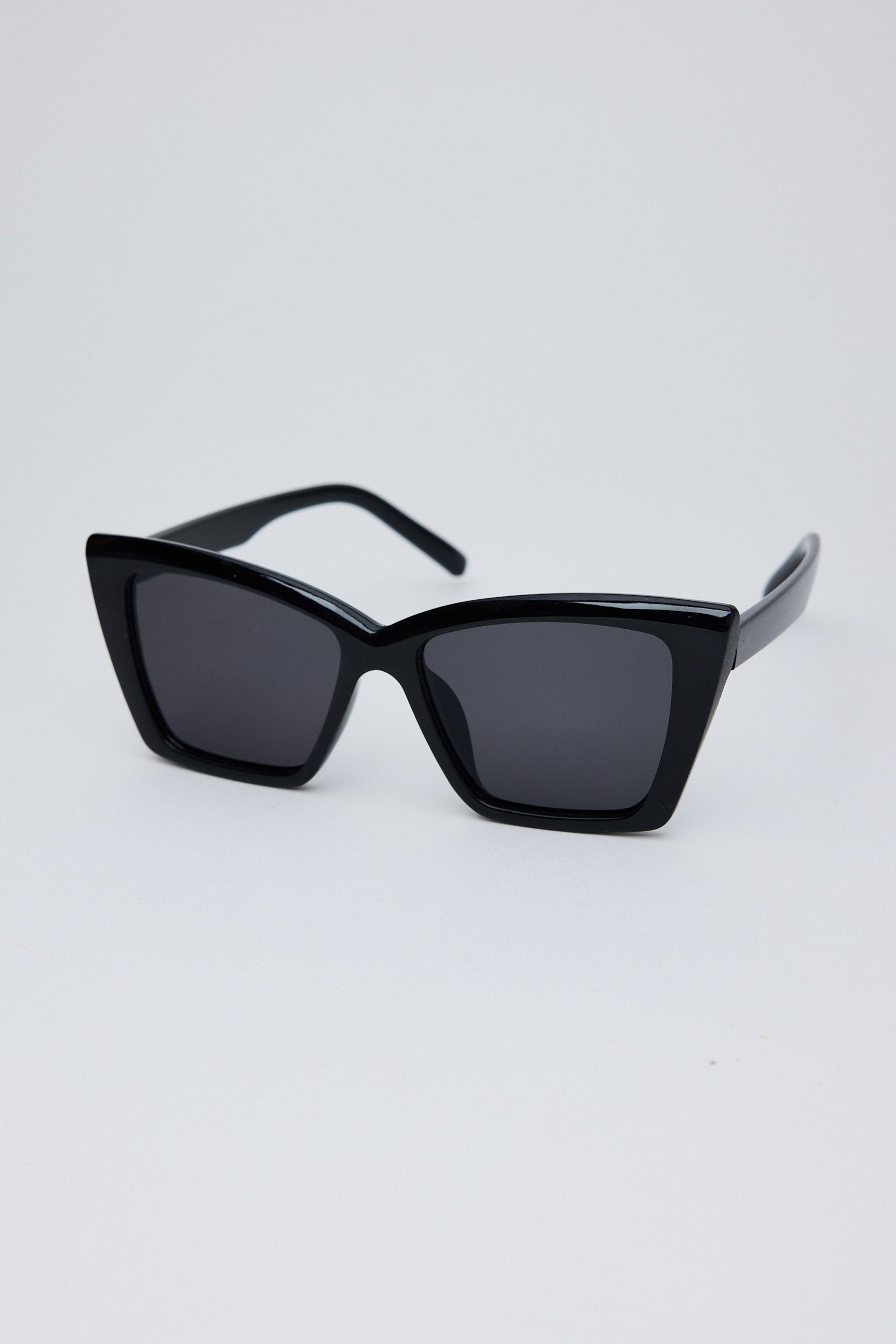 Black sunglasses on a light gray background