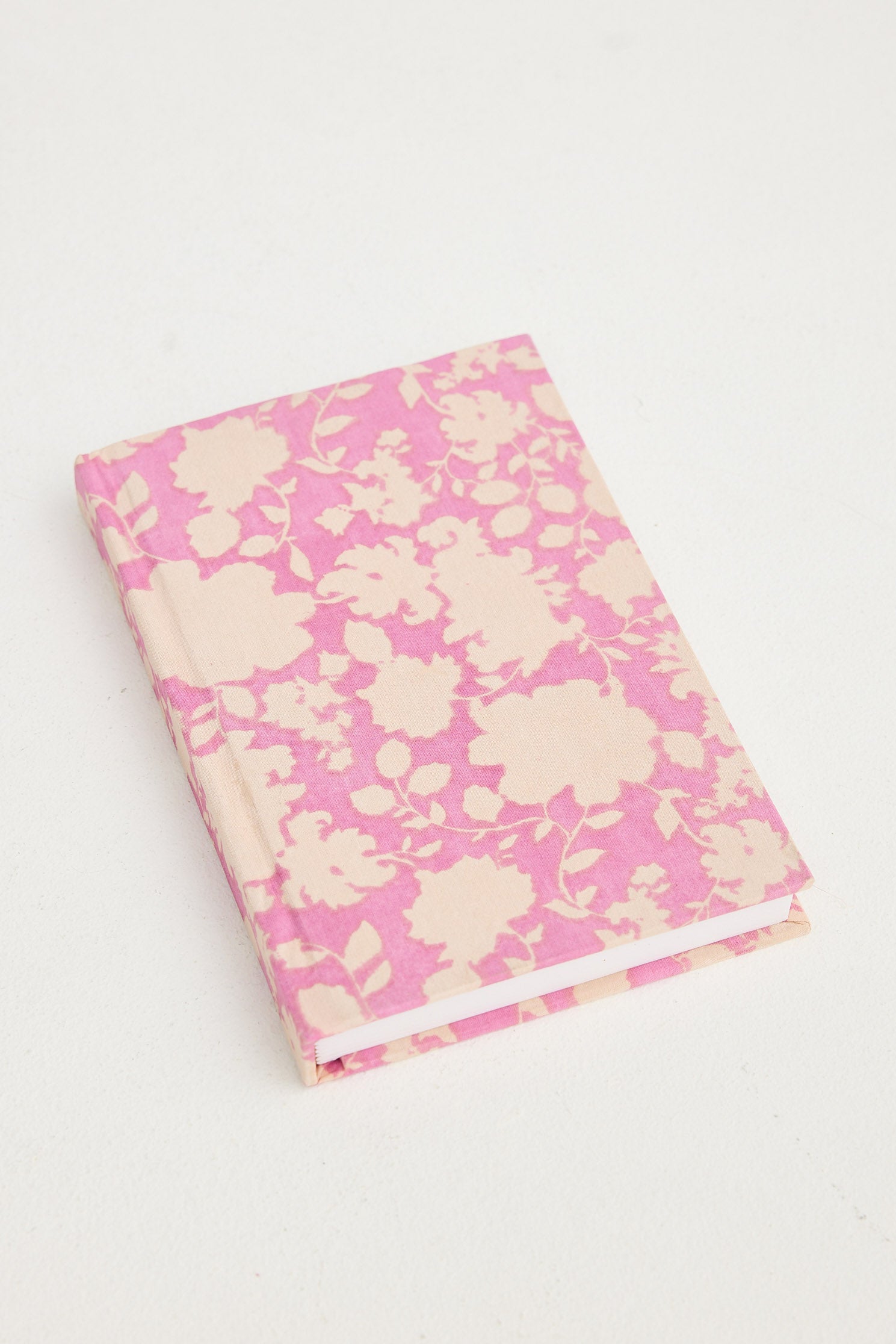 Floral-patterned notebook with pink and white design on a white background