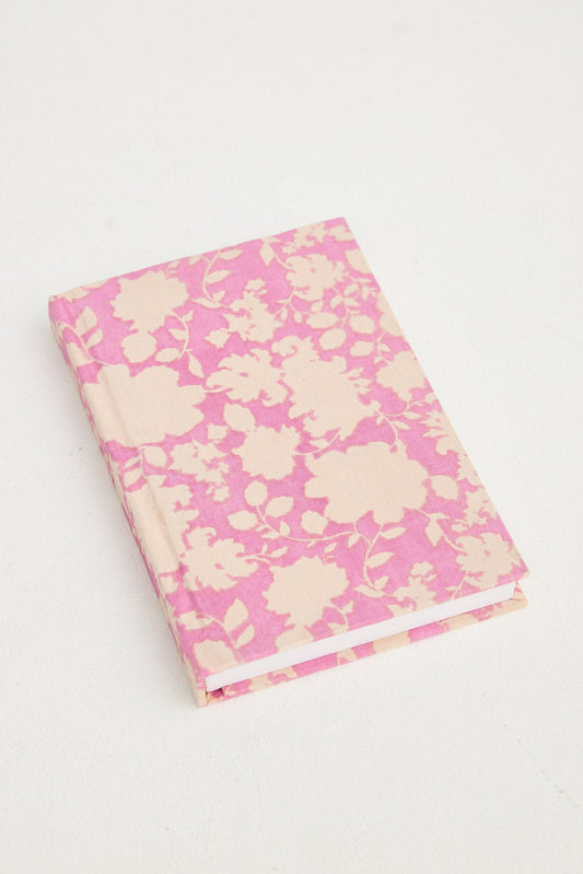 Floral-patterned notebook with pink and white design on a white background