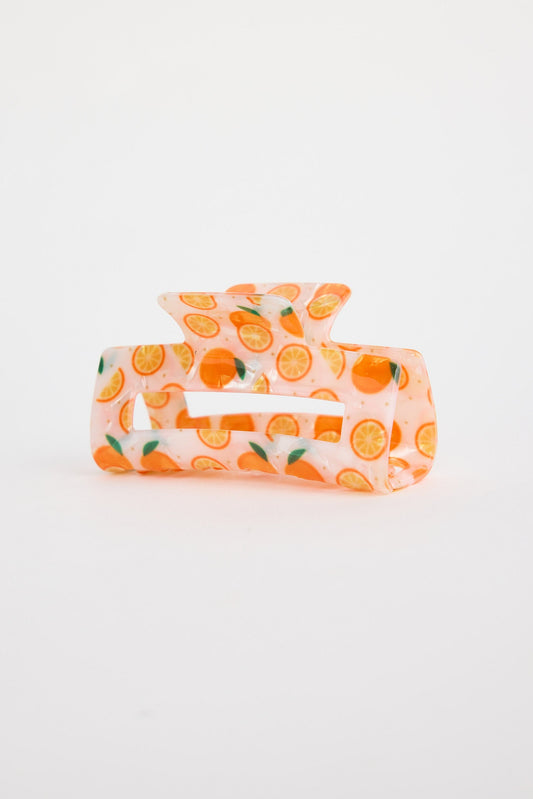 Hair clip with orange pattern on a white background