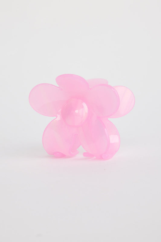 Pink flower shaped hair claw on a light gray background