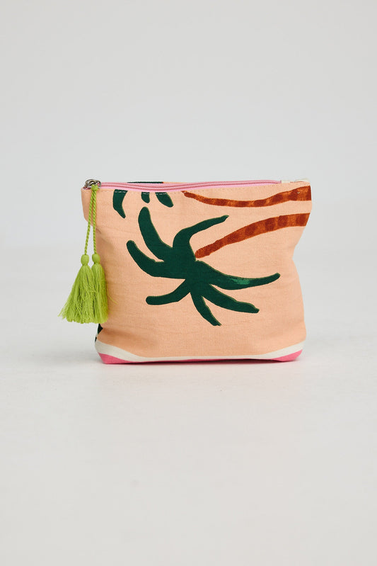 Small pouch with palm leaf design and tassel on a light gray background