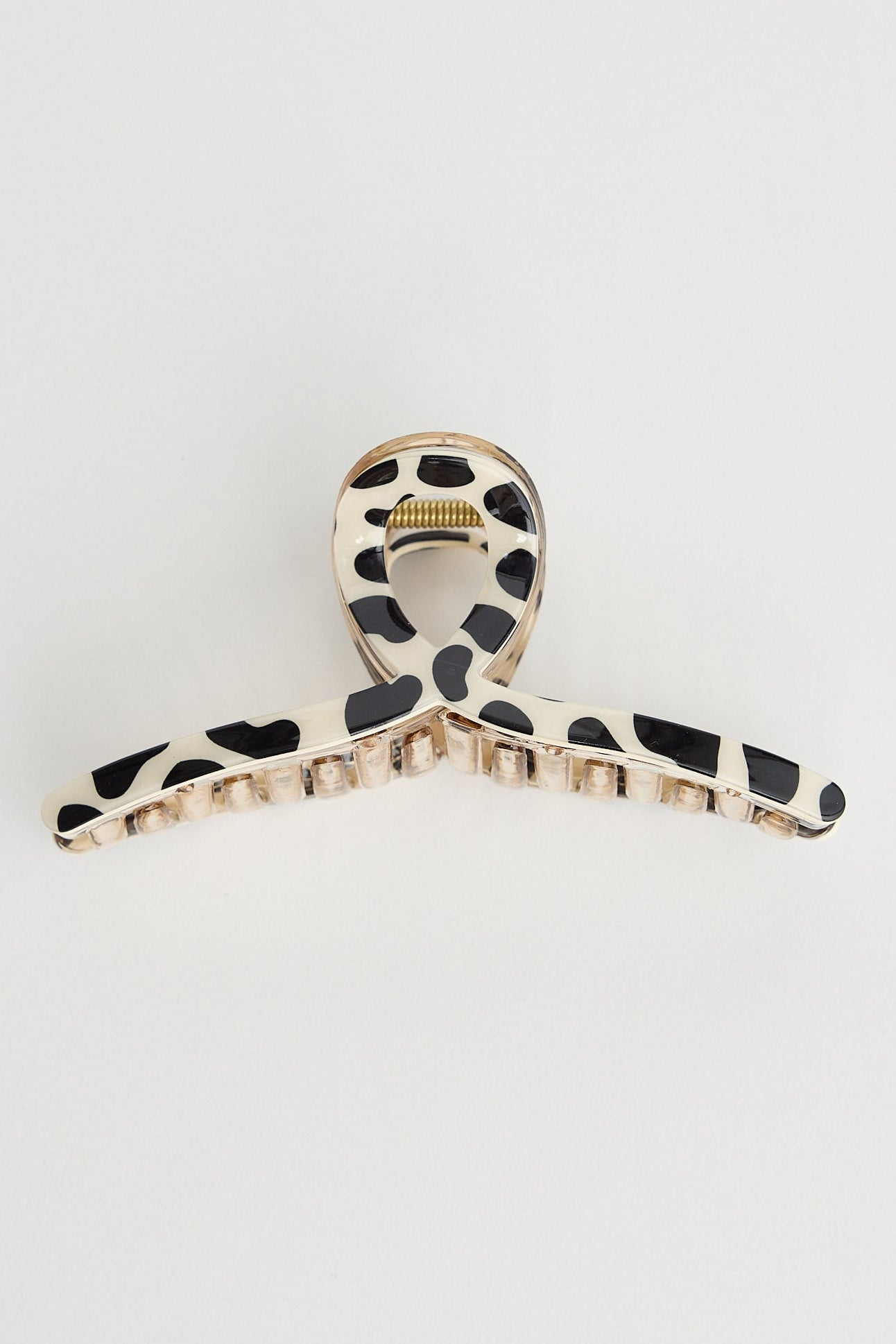 Hair clip with black and white pattern on a light gray background