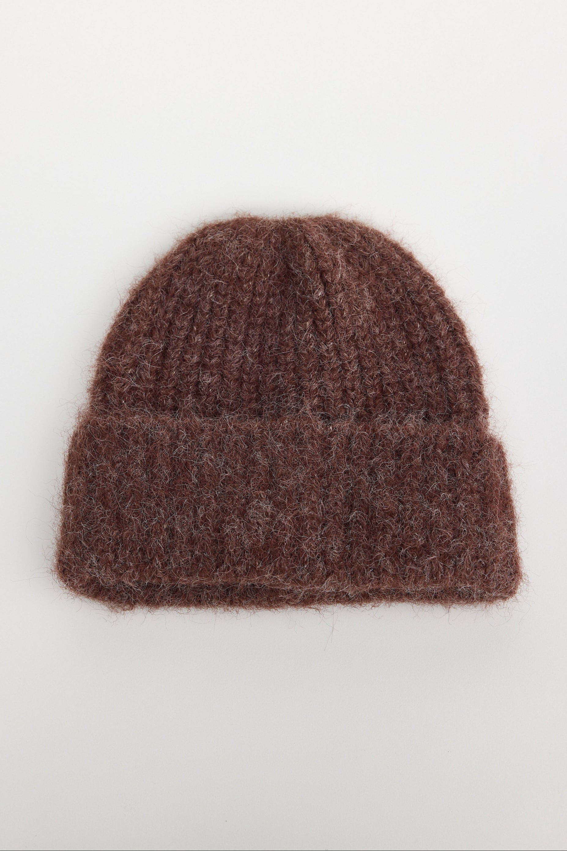 Brown knit beanie on a white background