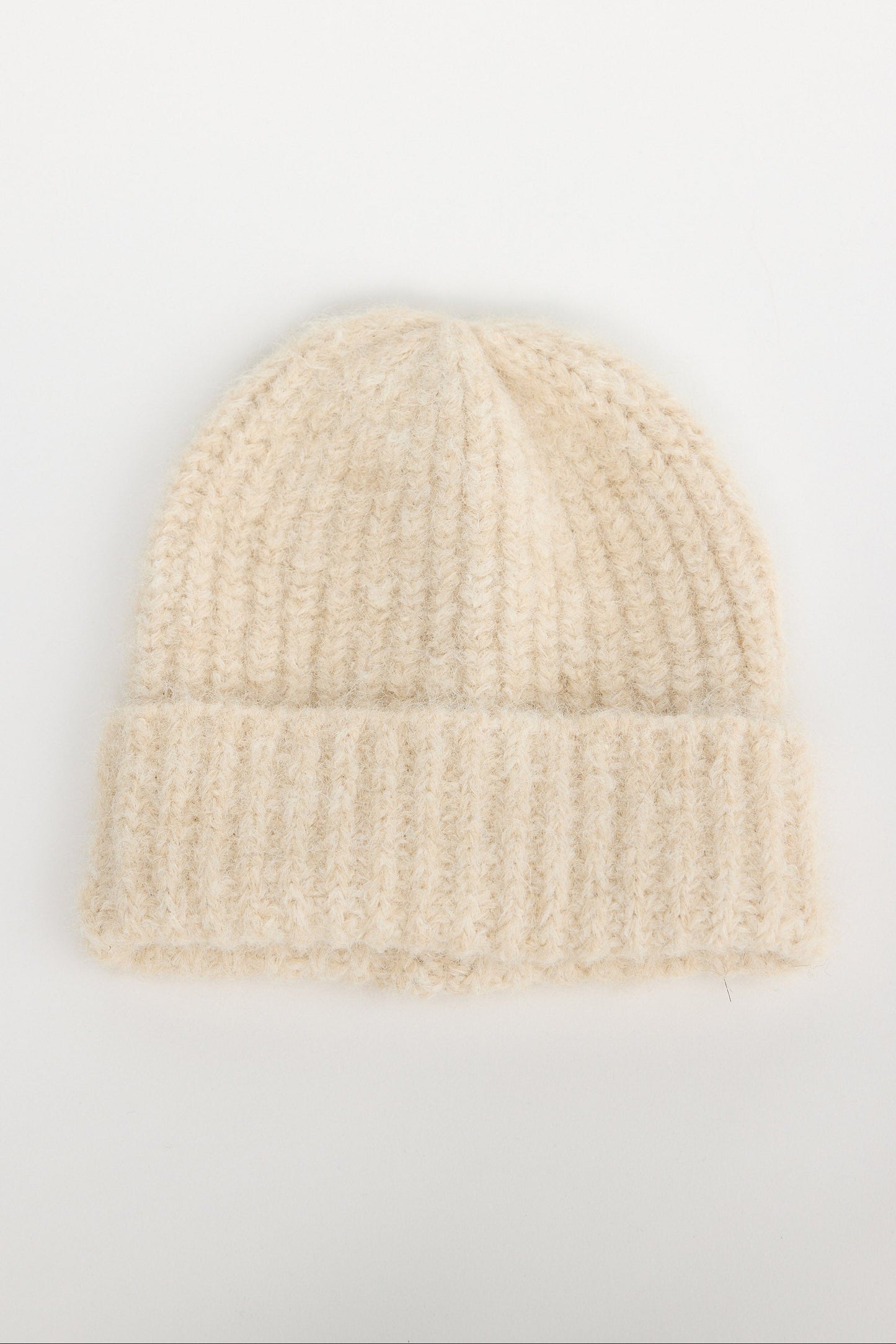 Beige knit beanie on a light gray background