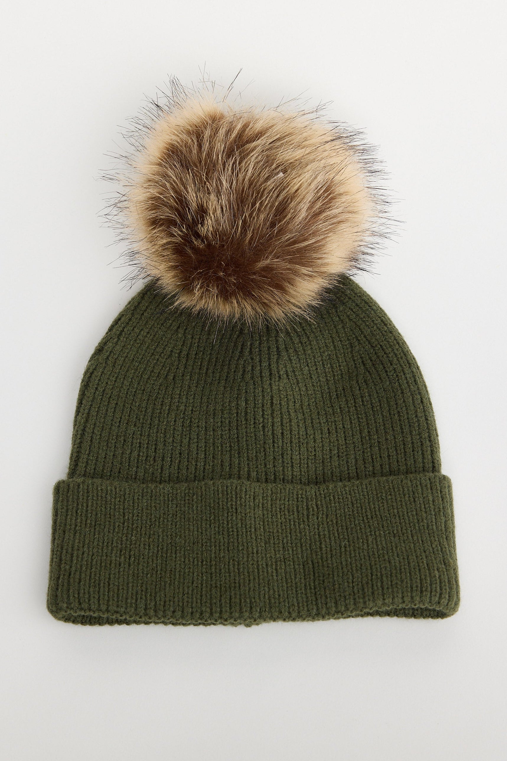 Green knit beanie with a fur pom-pom on a white background