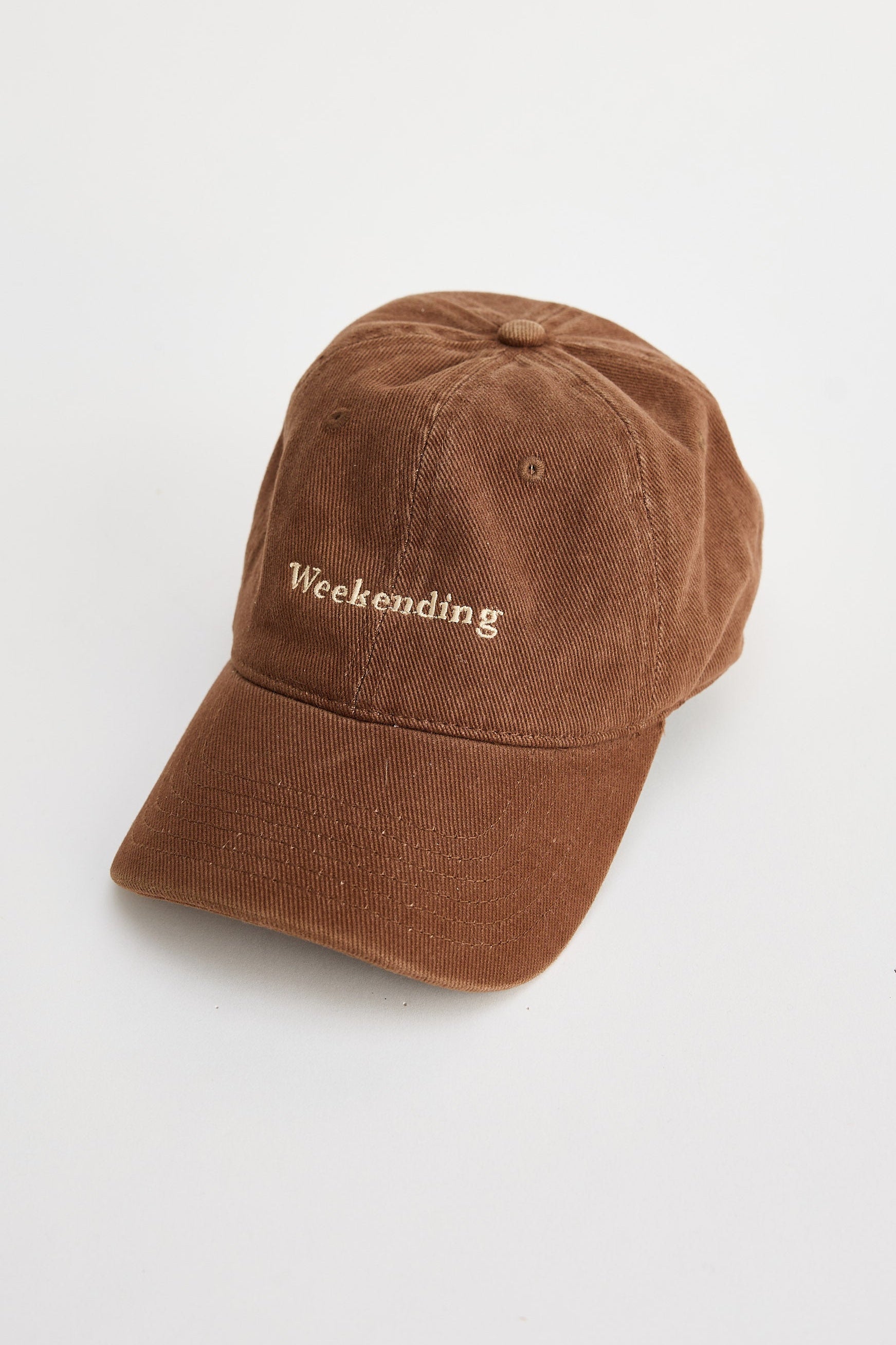 Brown cap with 'Weekending' text on a white background