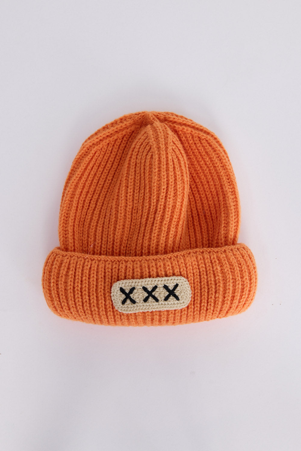 Benny Kids Beanie - Orange kids' beanie in orange with rib knit texture, front view on white background