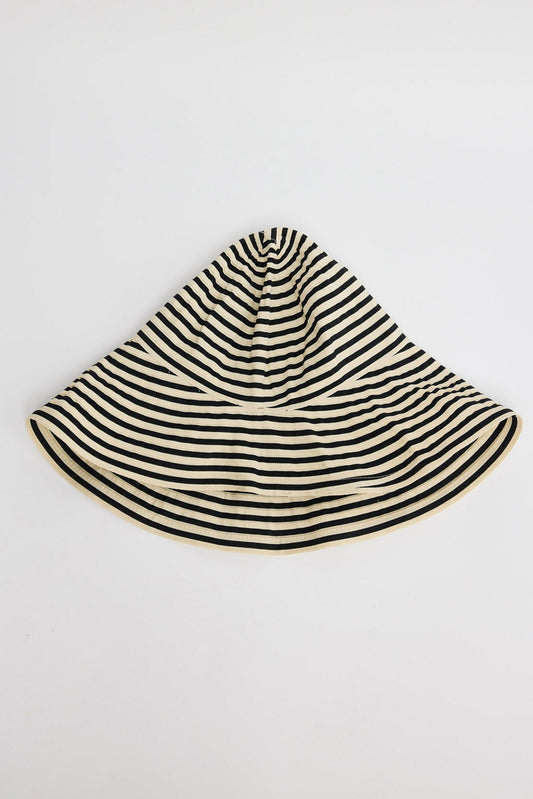 Wide-brim bucket hat in cream and black horizontal stripes with a soft unstructured crown, shown flat on a white background