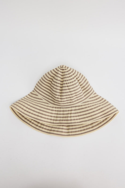 Wide-brim bucket hat in cream and taupe horizontal stripes with a soft unstructured crown, shown flat on a white background