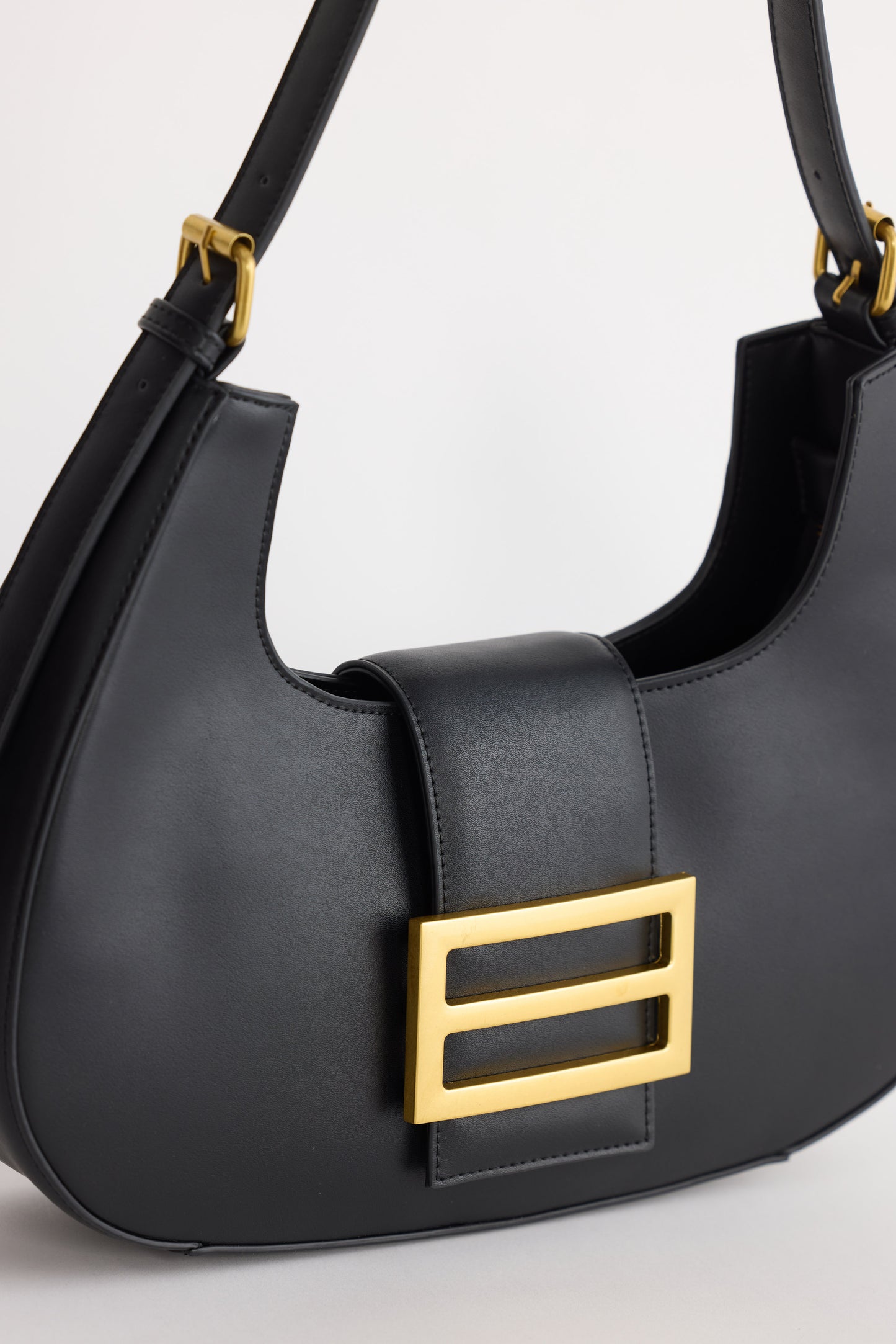 Virginia Handbag - Black handbag in black with gold-tone hardware, alternate view on white background