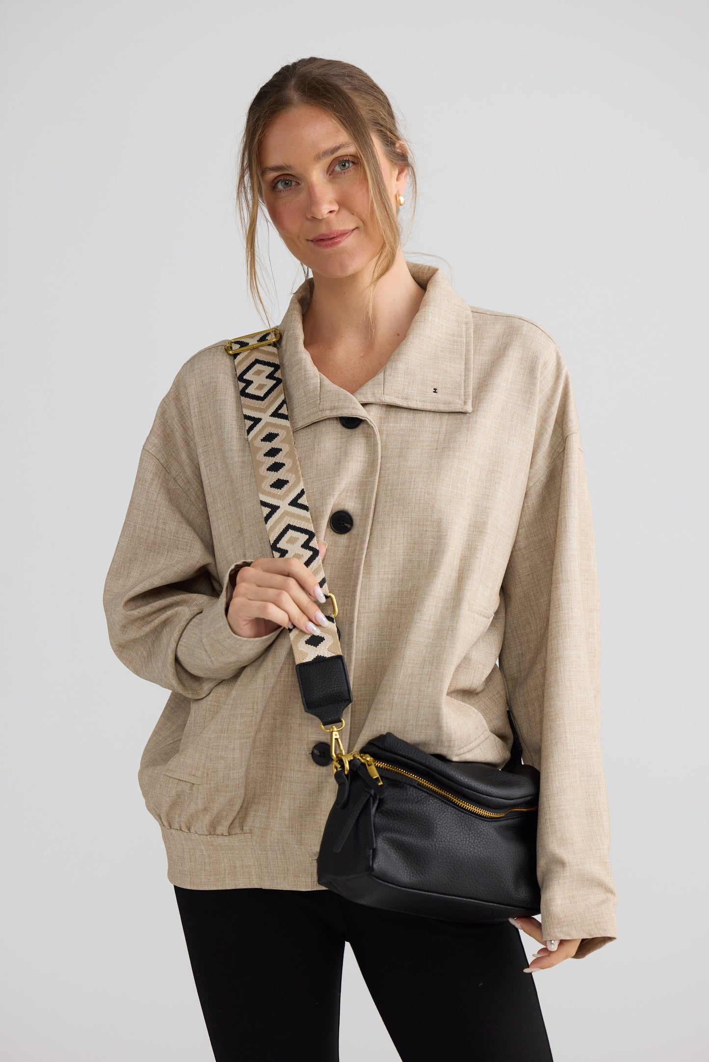 Sloane Crossbody Bag - Black crossbody bag in black with woven texture, styled view on white background