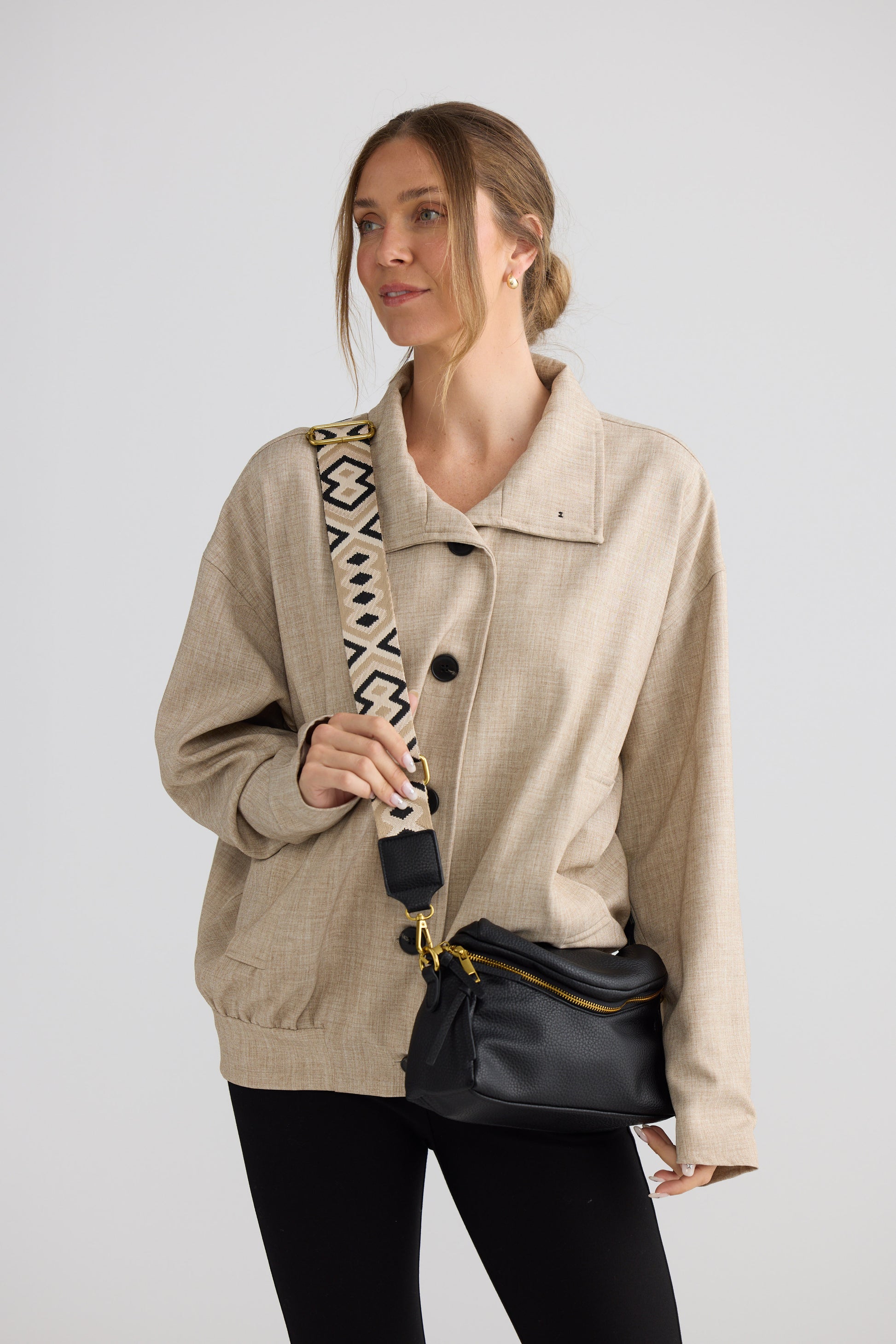 Sloane Crossbody Bag - Black crossbody bag in black with woven texture, detail view on white background