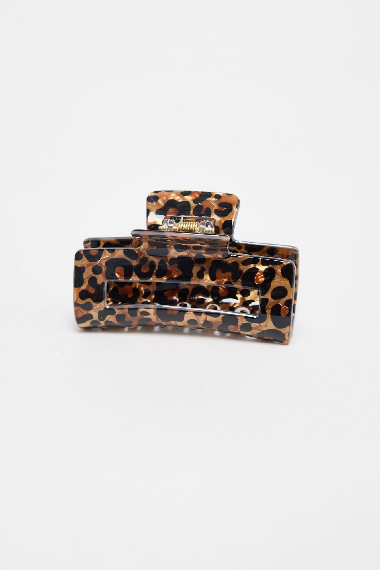 Zali Hair Claw in leopard-print acetate, shown at an angle highlighting the rectangular shape and gold spring hinge