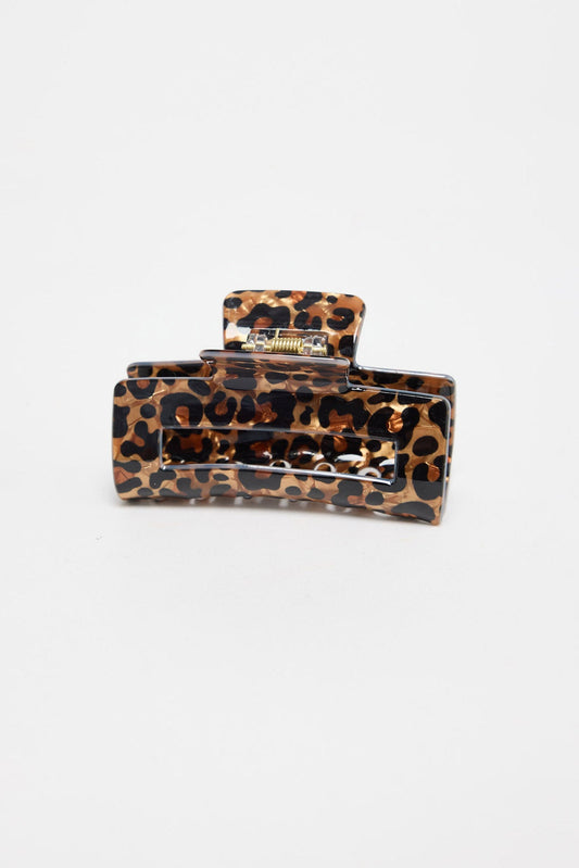 Zali Hair Claw in leopard-print acetate, shown at an angle highlighting the rectangular shape and gold spring hinge