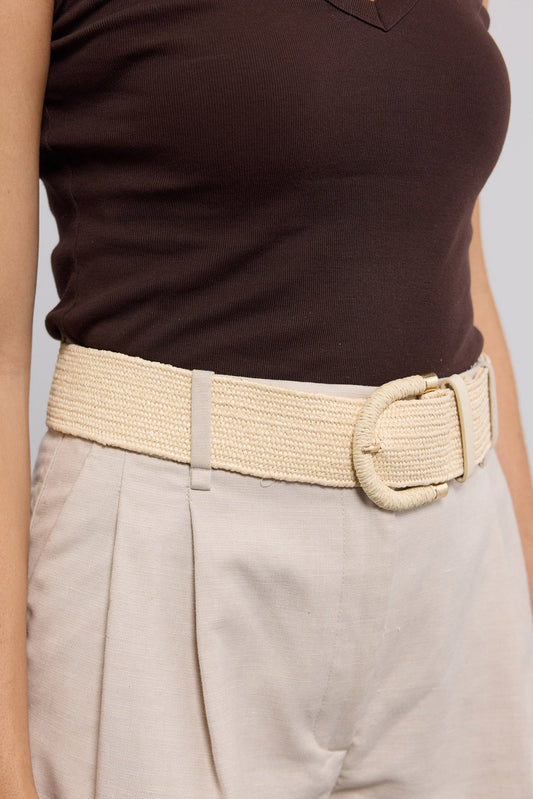 Reid Belt in beige worn cinched at the waist over a brown tank and cream trousers