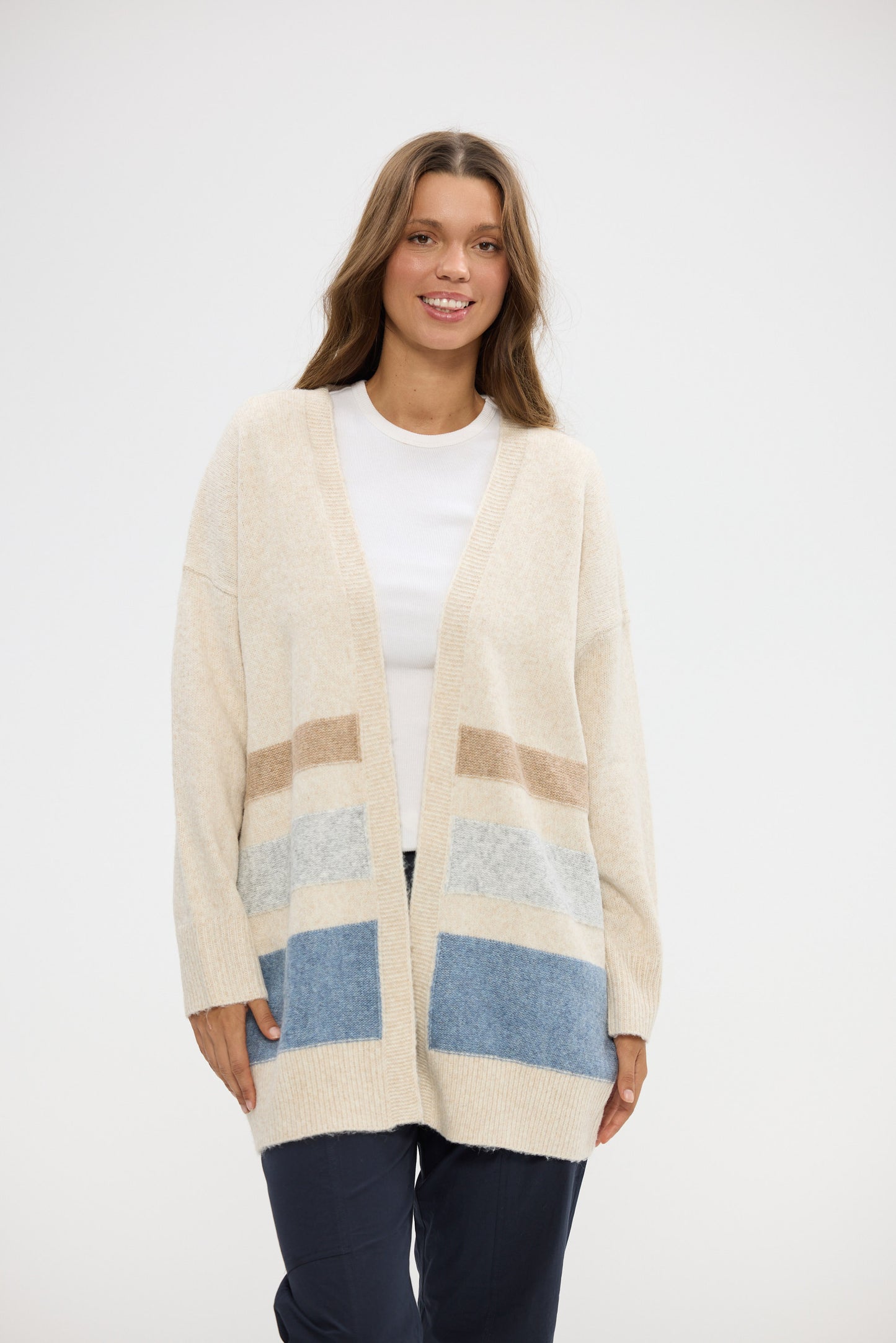 Woman wearing a patterned cardigan on a white background